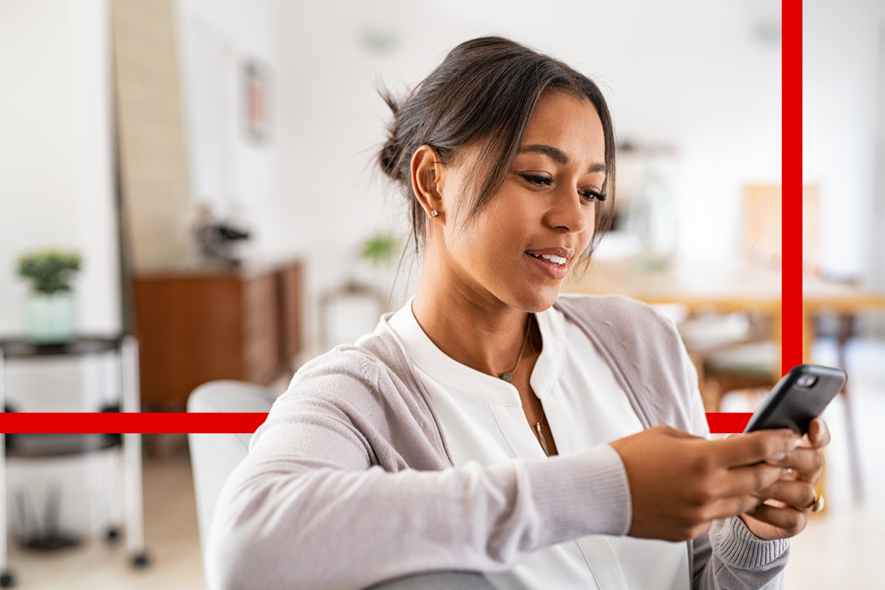 Woman typing on phone with graphic behind her